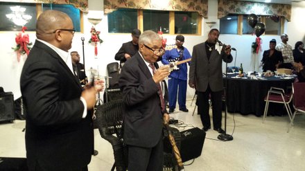 Judge Raymond Bolden with his oldest son Attorney Alan Bolden, from Washington D.C., is pictured giving a Champaign toast.