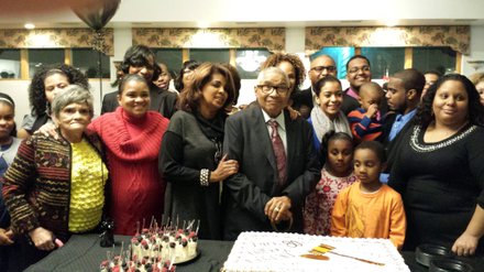 Judge Bolden is surrounded by family members as he gets ready to cut his birthday cake.