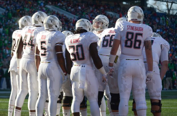 Maryland Terrapins quarterback C.J. Brown (center) leads a huddle in the first half of the 2013 Military Bowl on Friday, Dec. 27 at Jack Stephens Field at Navy-Marine Corps Memorial Stadium in Annapolis. The Marshall Thundering Herd defeated the Terrapins, 31-20.