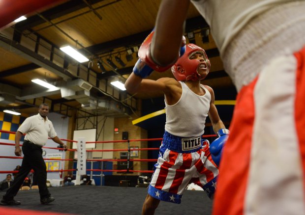 Kesean Bagwell attacks Lawrence Malcolm in the corner in the second round of a three-round bout at the District Heights Classic, an annual amateur boxing event, at the District Heights Municipal Center on Saturday, Jan. 4. Bagwell won the fight by decision.