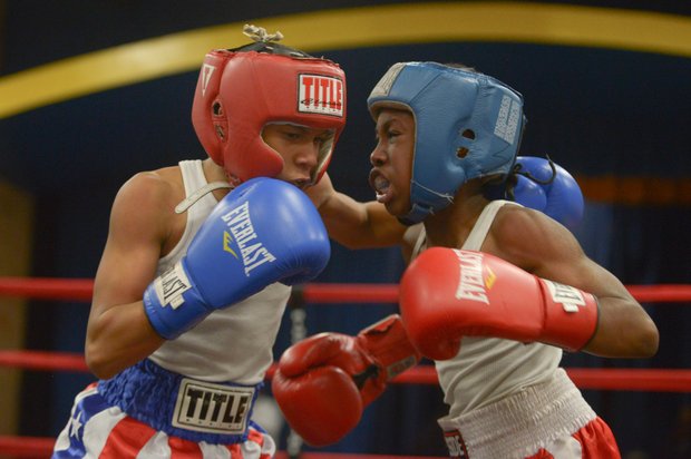 Kesean Bagwell (left) and Lawrence Malcolm go head to head during their boxing match at the District Heights Classic, an annual amateur boxing event, at the District Heights Municipal Center on Saturday, Jan. 4. Bagwell won the fight by decision.