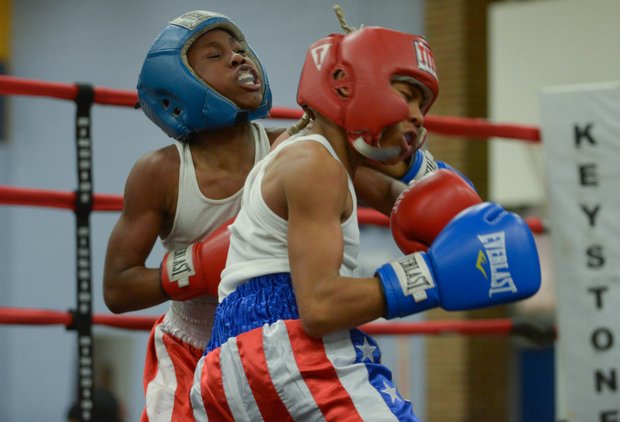 Lawrence Malcolm (left) lands a left hook against Kesean Bagwell in the second round of their boxing match at the District Heights Classic, an annual amateur boxing event, at the District Heights Municipal Center on Saturday, Jan. 4. Bagwell won the fight by decision.