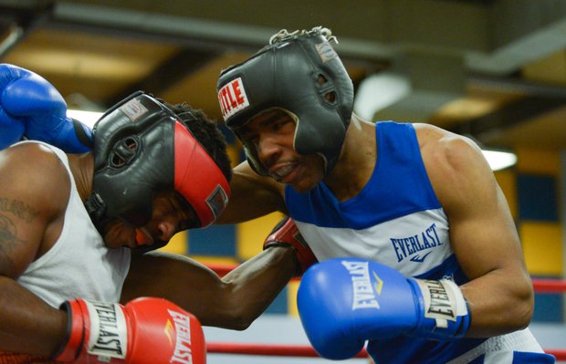 Davon Boone (left) tries to fight his way off the ropes against Gary Jones in the first round of their boxing match at the District Heights Classic, an annual amateur boxing event, at the District Heights Municipal Center on Saturday, Jan. 4. Boone won the match by decision.