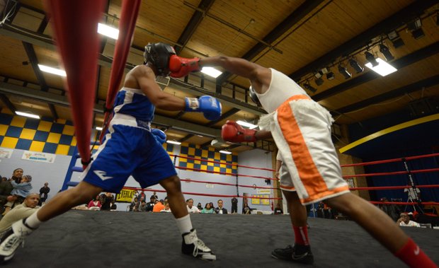 Davon Boone (right) lands a punch against Gary Jones in the first round of their boxing match at the District Heights Classic, an annual amateur boxing event, at the District Heights Municipal Center on Saturday, Jan. 4. Boone won the match by decision.