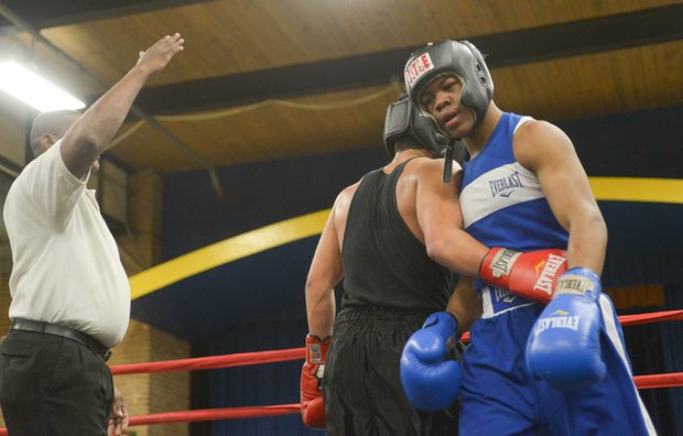 Tommy Avezar congratulates Gary Antwon Russell after their three-round amateur boxing match at the District Heights Classic, an annual amateur boxing event, at the District Heights Municipal Center on Saturday, Jan. 4. Russell won the match by decision.