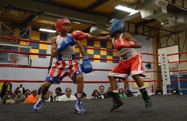 Kesean Bagwell (left) dodges a punch by Lawrence Malcolm in the first round of a three-round bout at the District Heights Classic, an annual amateur boxing event, at the District Heights Municipal Center on Saturday, Jan. 4. Bagwell won the fight by decision.