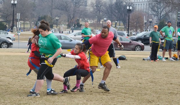 The NAKID flag football league enjoys an unusually warm day on the National Mall on Sunday, Feb. 2.
