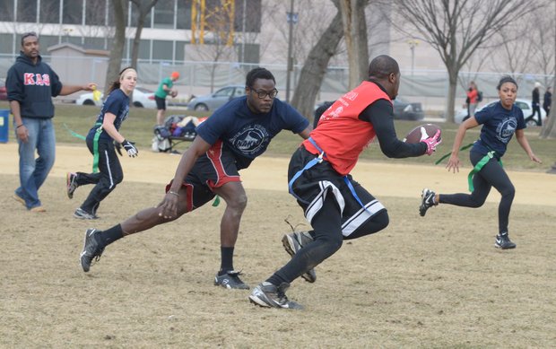 Abdul Zubair, 24, tries to grab a flag from Lenard Williams, 28, after Williams intercepted a pass during a flag football game on the National Mall in D.C. on Sunday, Feb. 2. The NAKID Winter Football League plays on the Mall on the weekends.