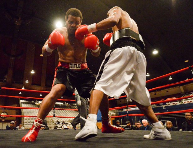 Julius Fogle lands a short left hook against Willis "The Prophet" Lockett during a six-round bout at the D.C. Armory on Friday, Feb. 7. Lockett won by unanimous decision.