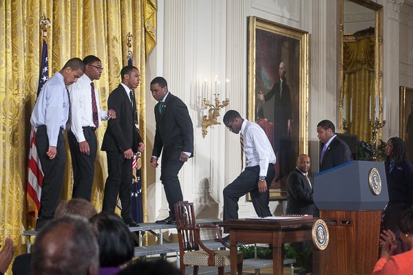 Members of Becoming a Man (B.A.M.), a program in Chicago, and boys from similar organizations throughout the nation, stand with President Obama in the White House as he rolls out his "My Brother's Keeper" initiative on Thurs., February 27.