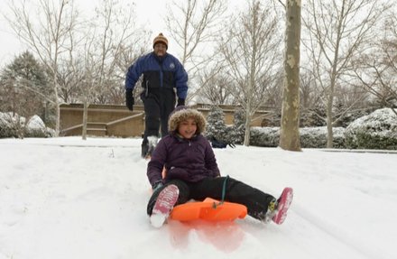 Vance Levy enjoys a snowy day with his daughter Jahmila, 8, at Meridian Hill Park in Northwest on Monday, March 3.