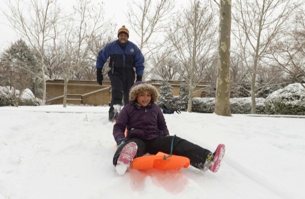Vance Levy enjoys a snowy day with his daughter Jahmila, 8, at Meridian Hill Park in Northwest on Monday, March 3.