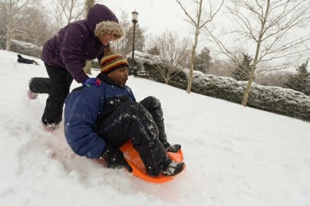 Vance Levy gets a push on his sleigh from his daughter Jahmila, 8, at Meridian Hill Park in Northwest on Monday, March 3.