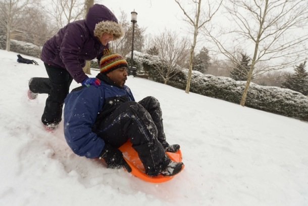 Vance Levy gets a push on his sleigh from his daughter Jahmila, 8, at Meridian Hill Park in Northwest on Monday, March 3.