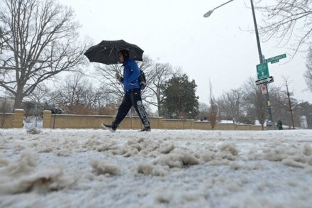 A man walks along 16th Street in Northwest D.C. on Monday, March 3, after the region was hit by a massive snowstorm.