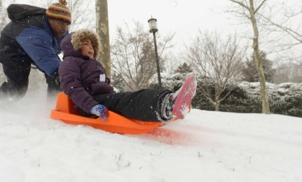 Vance Levy enjoys a snowy day with his daughter Jahmila, 8, at Meridian Hill Park in Northwest on Monday, March 3.