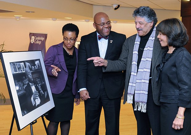 Former U.S. Senator William “Mo” Cowan (2nd l) is presented with a portrait from photographer Don West (2nd r) as part of Cambridge College’s ongoing Leadership Speaker Series. The portrait is part of West’s Portraits of Purpose exhibit which pays tribute to individuals known and unknown for their significant contributions to the communities in which they live. Joining them are Stacy Cowan (l) and Cambridge College President Deborah C. Jackson.