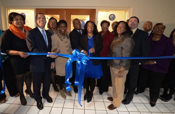 Maryland Lt. Gov. Anthony Brown (D), Prince George's County Executive Rushern Baker III (D), Prince George's County health officer Pamela Creekmur, Global Vision Community Health Center founder Toyin Opesanmi and others prepare to cut the ribbon at the Global Vision Community Health Center in Capitol Heights, Md., on Thursday, March 6.