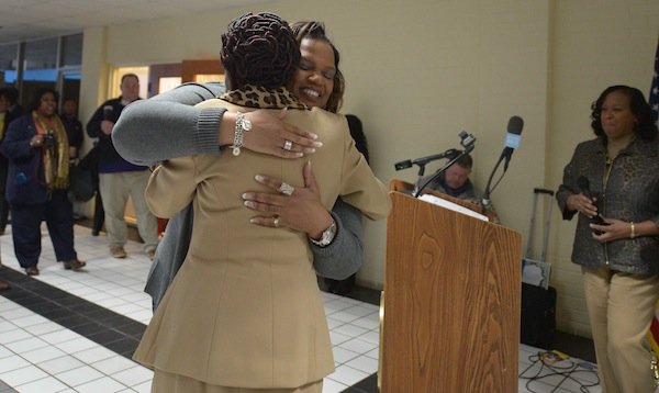 Prince George's County Council Member Ingrid Turner (D-District 4), hugs Global Vision Community Health Center founder Toyin Opesanmi during the grand opening of the health center in Capitol Heights, Md., on Thursday, March 6.
