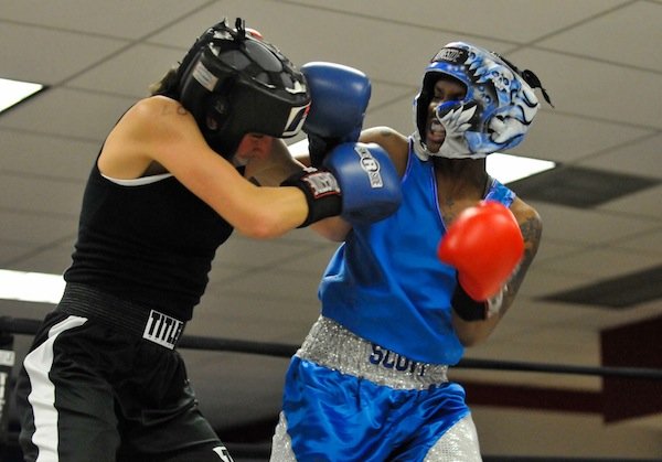 D'Ajah Scott (right) of the Diamonds Ruff Gym lands a punch against Courtney Feldheim during the third week of the 2014 Washington Golden Gloves Championship Tournament on Saturday, March 8, at the Sugar Ray Leonard Boxing Center in Hyattsville, Md.