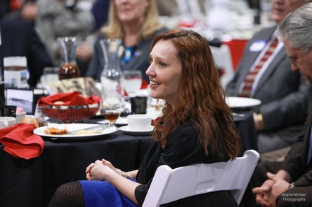 Romeoville Mayor John Noak's Wife, Jennifer, looks on as the mayor gave his State of the Village Address March 6 at Lewis University.