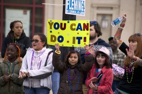 Virginian members of Girls on the Run hold up signs in D.C.'s Adams Morgan neighborhood and encourage participants of the Rock 'n' Roll Marathon in Northwest on March 15, 2014. Girls on the Run is a national organization that encourages girls to run.