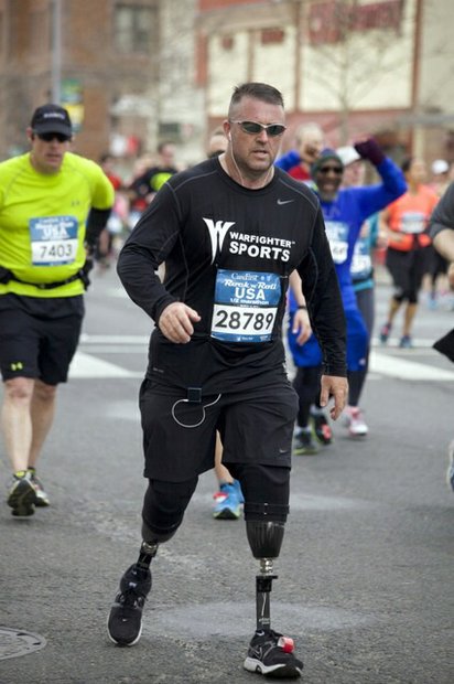 Military veteran Stephen Martin, running on two prosthetic legs, participates in the half-marathon version of the D.C. Rock 'n' Roll Marathon in Northwest on March 15, 2014. Martin wears a shirt representing Warfighter Sports, a national program that offers sports rehabilitation programs in military hospitals and communities.
