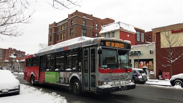 An off-duty Metro bus drives through the District on March 17, 2014, after a winter storm hit the region.