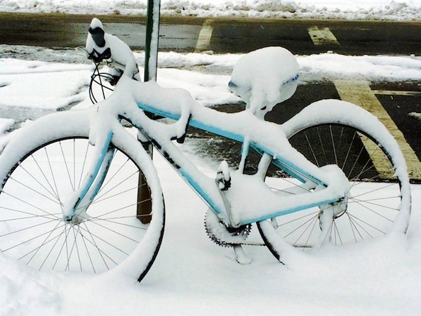 A bicycle chained to a street sign sits in front of the Christian Science Church in D.C.'s Adams Morgan neighborhood on March 17, 2014, after a winter storm hit the region.