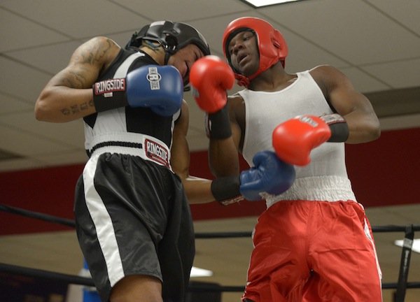 Teaquone Nance (Nomis Gym) trades blows with Justin Bell (NoExcuse) during a semifinals bout in the 2014 Washington Golden Gloves championship tournament at the Sugar Ray Leonard Boxing Center in Palmer Park, Md., on March 15. Bell won the match to advance to the finals.