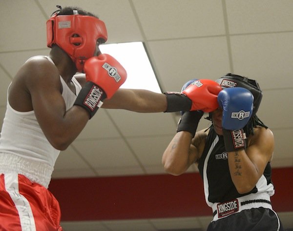 Justin Bell (NoExcuse) lands a jab against Teaquone Nance (Nomis Gym) in a semifinals bout in the 2014 Washington Golden Gloves championship tournament at the Sugar Ray Leonard Boxing Center in Palmer Park, Md., on March 15. Bell won the match to advance to the finals.