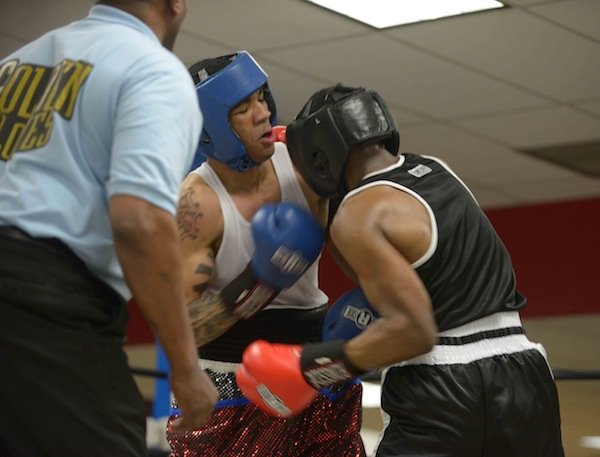 Monyae Gregory (Upton Gym) throws an uppercut against Andre Harris (Club One) during a semifinals bout in the 2014 Washington Golden Gloves championship tournament at the Sugar Ray Leonard Boxing Center in Palmer Park, Md., on March 15. Gregory defeated Harris to advance to the finals in Waldorf, Md., on March 29.