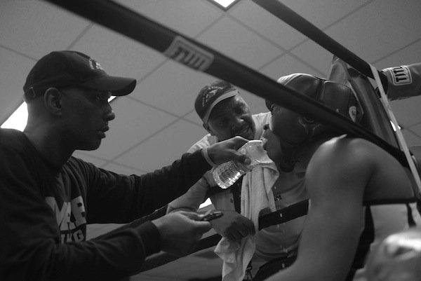 Cornermen tend to Dayshawn Jones (Umar Gym) between rounds of his bout with Carl Harper during the semifinals of the 2014 Washington Golden Gloves championship tournament at the Sugar Ray Leonard Boxing Center in Palmer Park, Md., on March 15. Jones defeated Harper to advance to the finals in Waldorf, Md., on March 29.