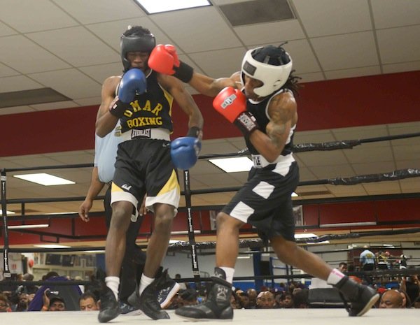 Jonathan Ludson (Monsters, Inc.) lands a solid right hook against Montell Pridgett (Umar) during a semifinals bout in the 2014 Washington Golden Gloves championship tournament at the Sugar Ray Leonard Boxing Center in Palmer Park, Md., on March 15. Pridgett won to advance to the finals.