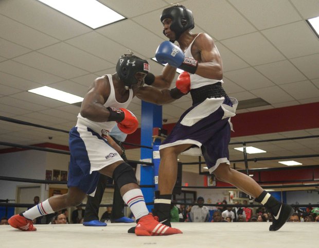 Jerome Featherstone (Baltimore Boxing) lands a body blow against Tavon Body (Headbangers) during a semifinals bout in the 2014 Washington Golden Gloves championship tournament at the Sugar Ray Leonard Boxing Center in Palmer Park, Md., on March 15. Body beat Featherstone to advance to the finals.
