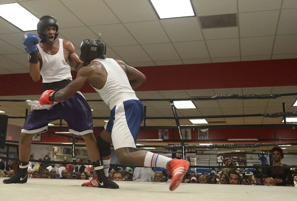 Tavon Body (Headbangers) lands a punch against Jerome Featherson (Baltimore Boxing) during a semifinals bout in the 2014 Washington Golden Gloves championship tournament at the Sugar Ray Leonard Boxing Center in Palmer Park, Md., on March 15. Body defeated Featherstone to advance to the finals.