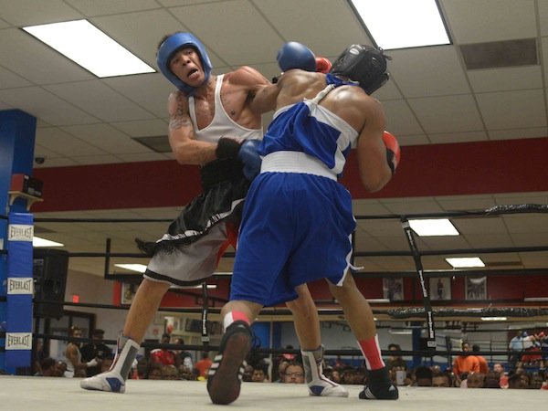 From left: Malik Hawkins (Upton Gym) gets tangled up with Drayvontay Speed-Rawls during a semifinals bout in the 2014 Washington Golden Gloves championship tournament at the Sugar Ray Leonard Boxing Center in Palmer Park, Md., on March 15. Hawkins beat Speed-Rawls to advance to the finals.