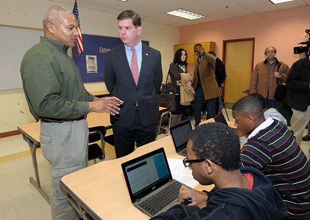 Mildred Avenue School 8th grade social studies teacher Ronaldo Shelbourne explains to Mayor Martin Walsh what his students are doing with the new Chromebooks during class time.