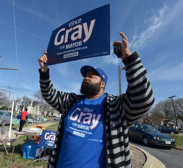 A supporter for D.C. Mayor Vincent Gray campaigns on April 1, the day of the Democratic primary election. Gray faces seven candidates in his re-election bid.