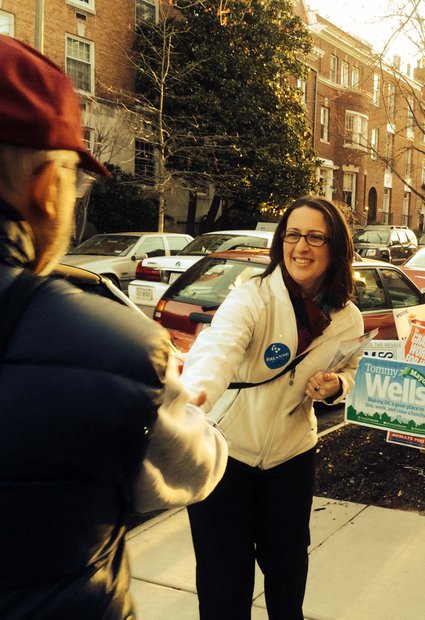 Ward 1 Council candidate Brianne Nadeau shakes hands with potential voters at Precinct 25 on Kalorama Road, in Northwest on DC Primary Day. /Photo by Nancy Shia