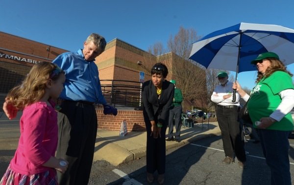 D.C. Council member and mayoral candidate Muriel Bowser talks with supporters outside of Polling Precinct 52 in Northwest during a campaign stop on April 1, the day of the city's Democratic primary.