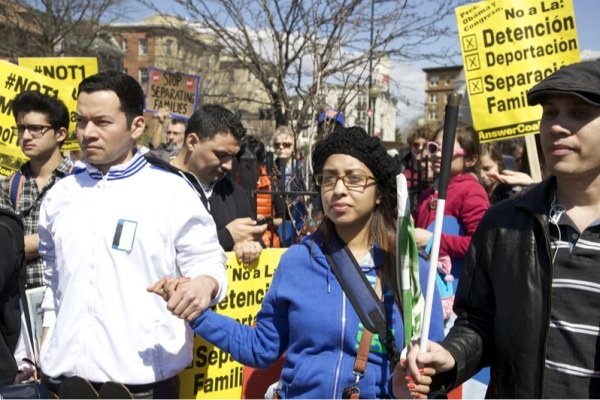 A march in D.C. for immigrant rights in Lamont Park in Mount Pleasant begins with a prayer on April 5, 2014.