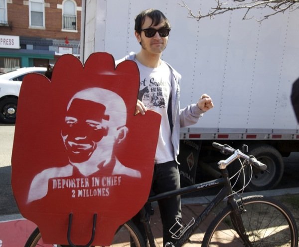 Walker Grooms, 30, readies his bicycle and sign for a march in D.C. for immigrant rights march on April 5, 2014.