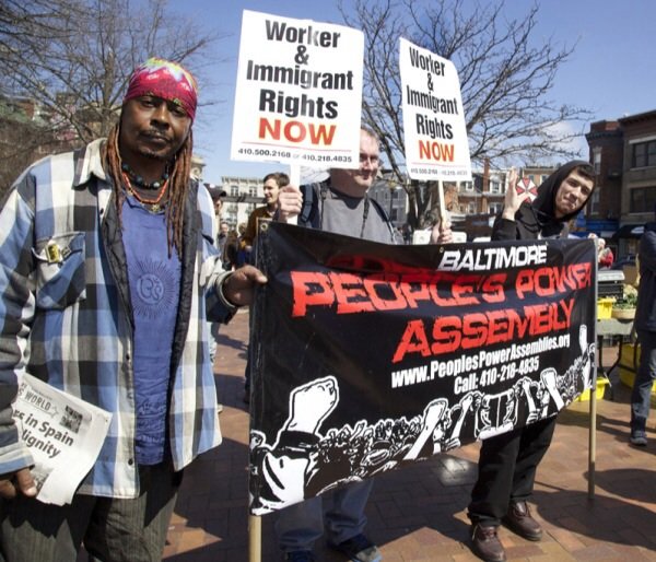 Baltimore residents Lee Patterson, 59, Bruce Emmerling, 43, and Brandon Wallace, 27, gather in D.C.'s Lamont Park in the Mount Pleasant neighborhood in Northwest for a march for immigrants rights on April 5, 2014.