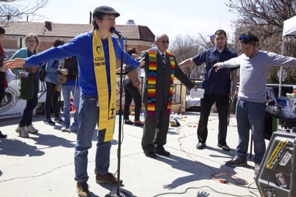Revs. Cathy Rion-Starr and Jose Palacio say a prayer during a rally in Lamont Park in Mount Pleasant before a march for immigrant rights on April 5, 2014.
