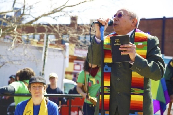 Rev. Jose Palacio of Calvary Baptist Church in Northwest D.C. gives a prayer during a rally in Lamont Park in Mount Pleasant before a march for immigrant rights on April 5, 2014.