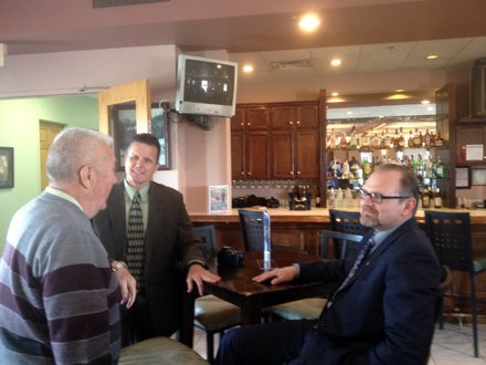 Lockport Mayor Steve Streit (sitting) chats with guests before giving his State of the City Address.