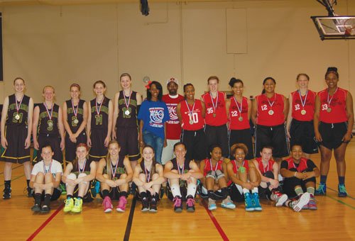 Tournament organizers Shay Washington and Shawn Martin (center) join the Rex Putman and 503 Rebels teams at center court at Self Enhancement, Inc., the site of the 2014 Joyce Washington Classic.
