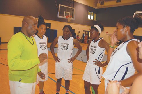 Coach Michael Mangum counsels his Joyce Washington Classic Team who would go on to beat the 503 Rebels in the Joyce Washington Classic Girls Championship by a score of 76-68.