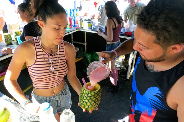 Melissa and Jonathan prepare a guava smoothie at the Black Iguana drink tent.